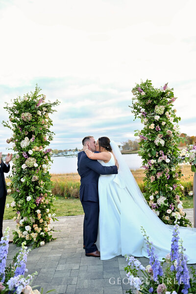 Wedding couple ceremony kiss during outdoor ceremony at Danversport