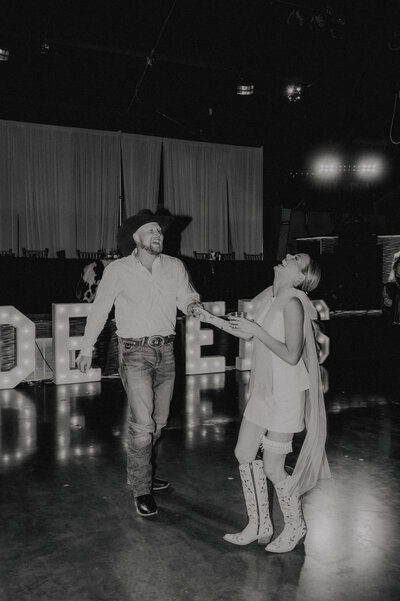 couple having fun on the dance floor taken by oklahoma wedding photographer