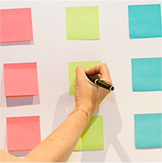 Image of Emily May using post-it notes to plan her work