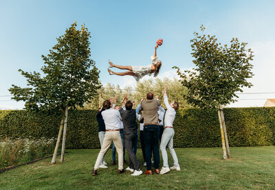 Bruid vliegt in de lucht, vrienden, huwelijksfeest