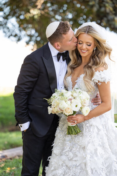 A groom resting his head on a brides head