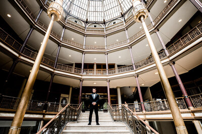 groom standing on steps at the Cleveland hyatt regency at the arcade