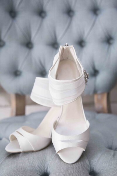 White bridal shoes on blue chair