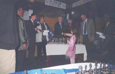 Picture of the founder in 2006 accepting a reward in chess, dressed in all pink