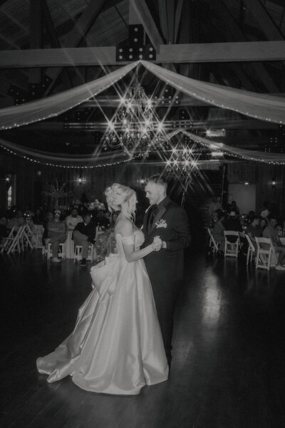 black and white image of bride and groom at their first dance