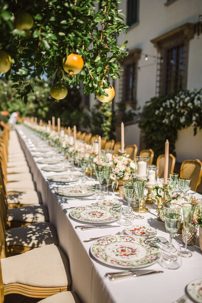 long table at wedding reception featuring lemons and a lemontree, which was taken at a Le Piazzole villa and winery wedding reception in Florence Italy