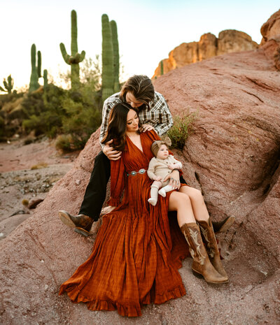 family on rocks with baby