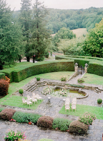 Sunken garden wedding ceremony at Hedsor House with a lily pond backdrop