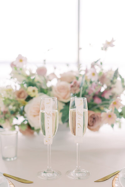 Romantic blush floral centerpiece by Lilyput Floral and Champagne Glasses