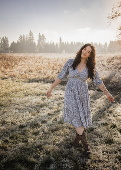 Oregon High School Senior playing in an open field during her senior portrait session