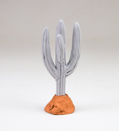 a saguaro cactus shaped ring holder made out of ceramic
