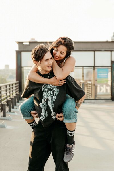 Man Giving Woman a Piggyback Ride on Rooftop