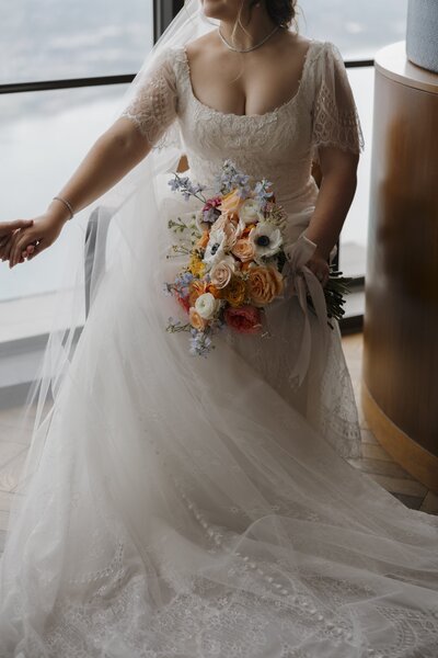 bride wearing her dress holding her bouquet