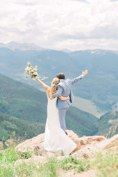 A fine art film photographer in Colorado photographs a bride looking out the window.