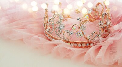 Pink and gold diamond crown on pink fabric