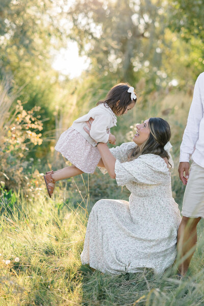 mother and daughter hugging in field