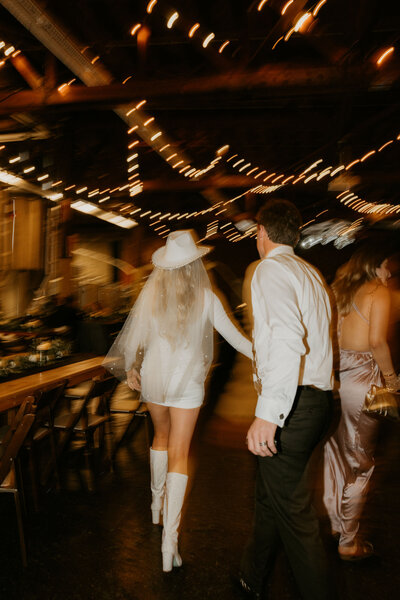 Savannah and Callen’s joyful reception exit under string lights, coordinated by Beyond the Event and photographed by Kellie Jane Photography.
