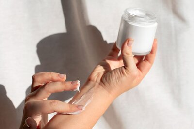  Hand applying skincare cream, featured in beauty PR visuals by SA Communications PR agency