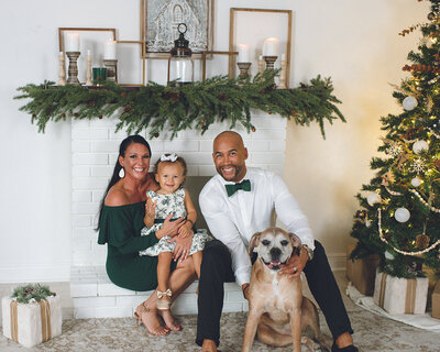 family on a fireplace with pet dog for holiday portraits