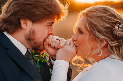 photo of groom kissing his bride's cheek