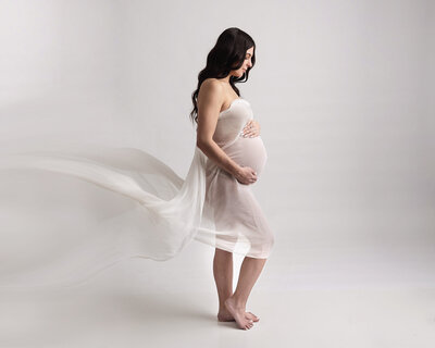 Mom to be draped in fine fabric for maternity pictures in murrysville studio.