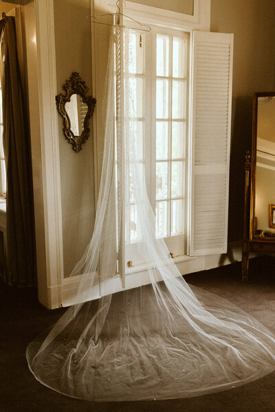 wedding veil hanging on window