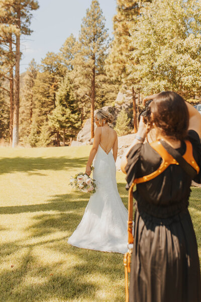 Behind the scenes photo of Aurelia photographing one of her brides on a wedding day.