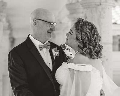 BRIDE AND GROOM LOOKING AT EACH OTHER AND SMILING AT ART CENTER IN CORPUS CHRISTI, TX