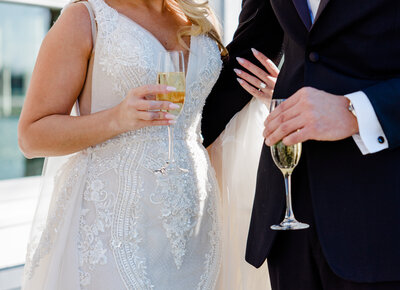 wedding detail couple holding onto champagne  glasses