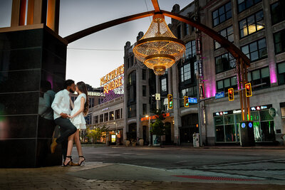 Couple walking under a chandelier in downtown Cleveland, captured by TheWiz Photography
