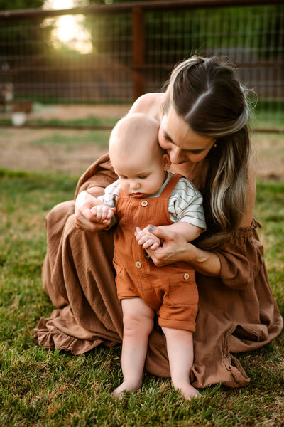Mom holding son in family farm in Phoenix, Arizona.