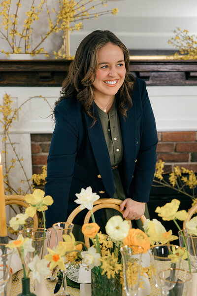 owner of sarah brennan events posing with her table setup