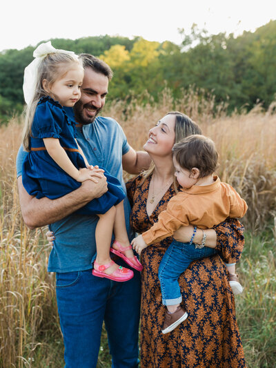 girl in orange dress posing for family photos at westcreek reservation Cleveland family photography