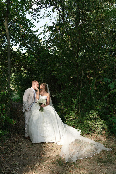 Bride and groom kissing under the veil in black and white at Germantown Gables in Louisville KY
