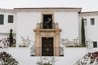 Couple kissing in window at Wrigley Mansion in Phoenix, Arizona