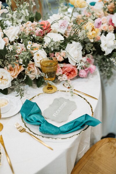 Elegant lunch table setup with florals and amber glasses