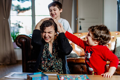 Brothers playing with their mom
