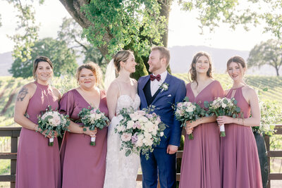 bay area photographers captures wedding ceremony in sonoma with bride laughing while her groom shares his vows in outdoor California wedding venue for a luxury wedding