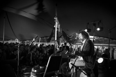 Black and white photo of guitarist playing at Feile Nasc