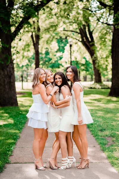 4 Senior girls in their cute white dresses together