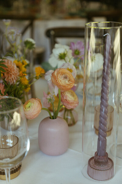 Wedding flowers and candles on a reception table at Calamigos Ranch at the Pavilion 