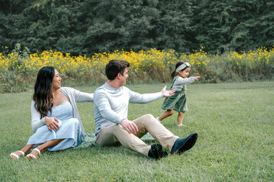 a family of five sitting on a park at coker arboretum and having their photo taken by rosa ashdown