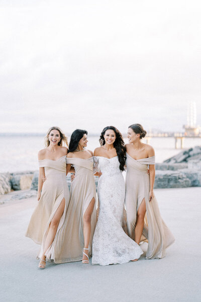 Bride with bridesmaids in champagne dresses at waterfront wedding near Toronto