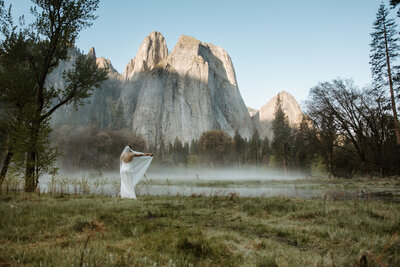 Bride walking alone on forest trail during Yosemite elopement