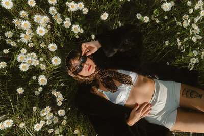 portrait of portland elopement photographer standing in dried grasses with hand on head in oregon