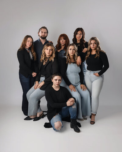 A group stands and sits together in a circle for their brand photos. 