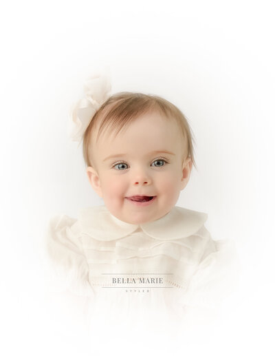 Baby girl in cream Peter Pan collar top with cream bow