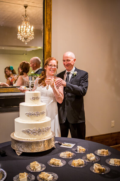 Kansas Wedding Couple Toasting With Cake