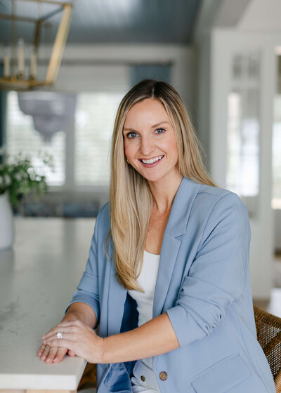 A headshot of Rachel Somplasky, she is smiling and wearing a blue blazer