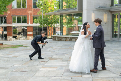 A videographer recording a newlywed couple 